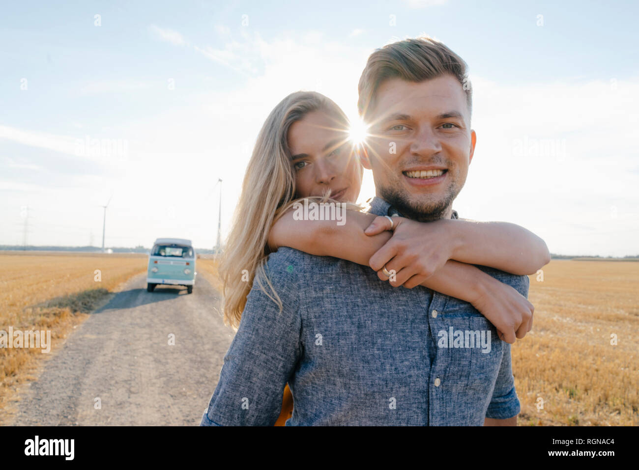 Portrait of happy young couple at camper van in rural landscape Stock ...