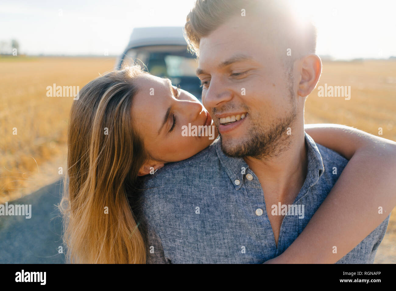 Affectionate young couple at camper van in rural landscape Stock Photo ...