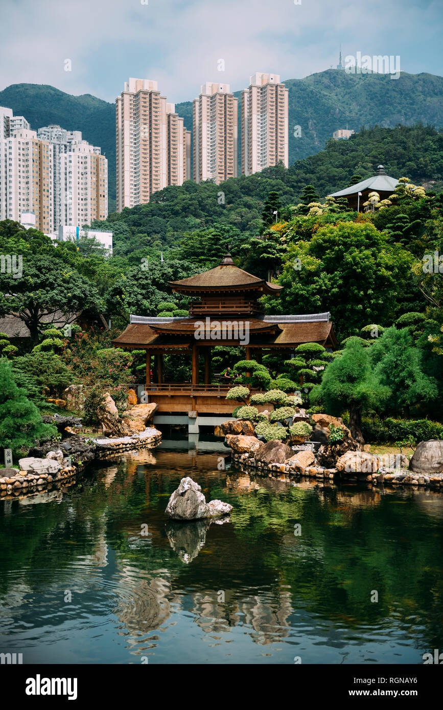 China, Hong Kong, Diamond Hill, Pond in Nan Lian Garden surrounded by skyscrapers Stock Photo