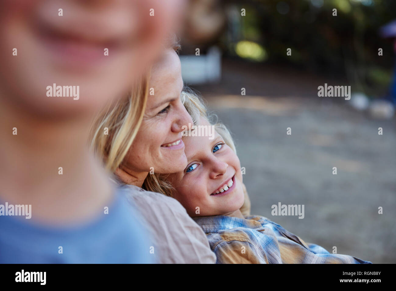 Happy mother with two sons outdoors Stock Photo