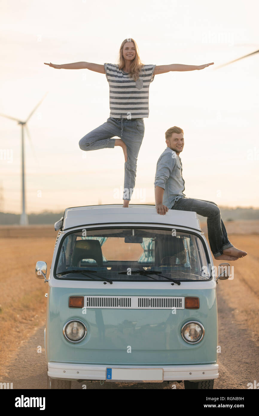 Young couple on roof of a camper van in rural landscape Stock Photo - Alamy