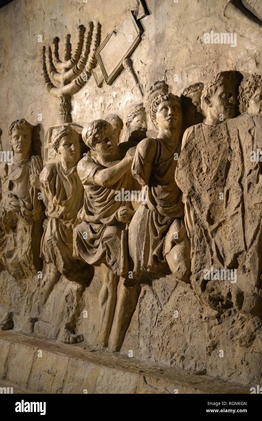 Wall relief on arch of titus depicting Menorah taken from temple in Jerusalem in 70 AD Stock Photo