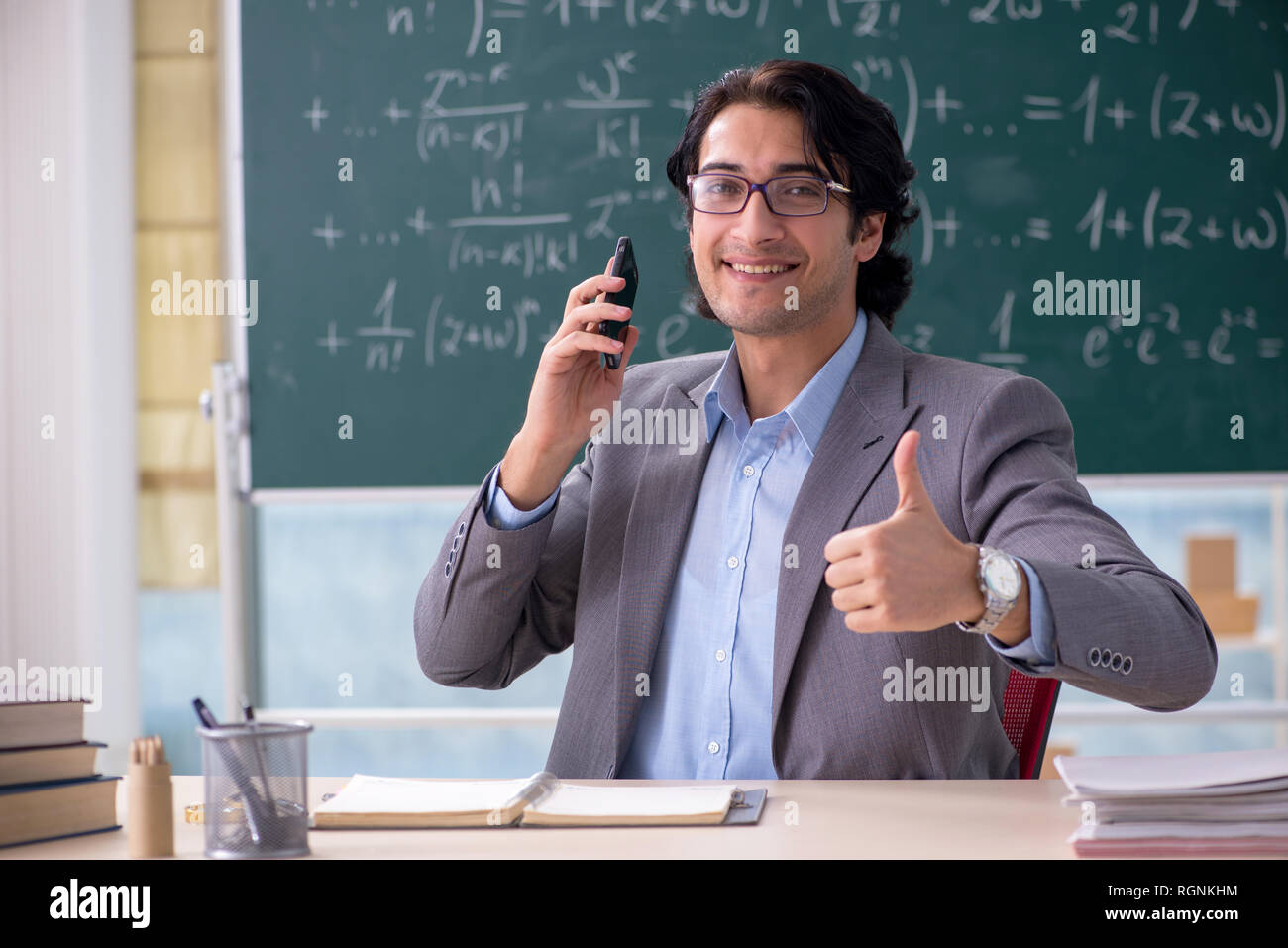 Young handsome math teacher in classroom Stock Photo