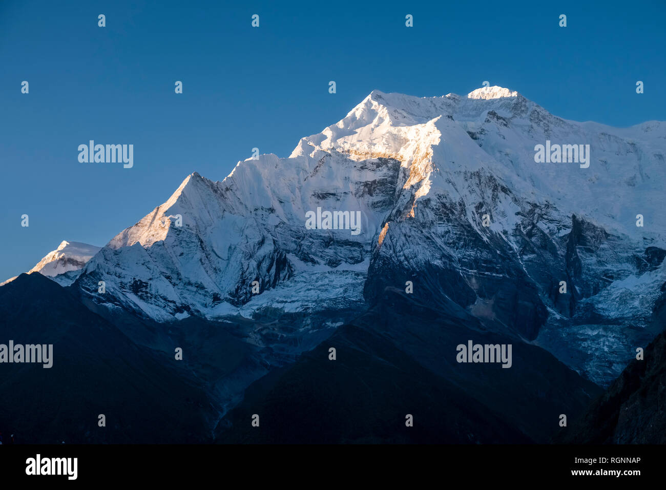 View across the Upper Marsyangdi valley to the snow covered summit of Annapurna 2 Stock Photo