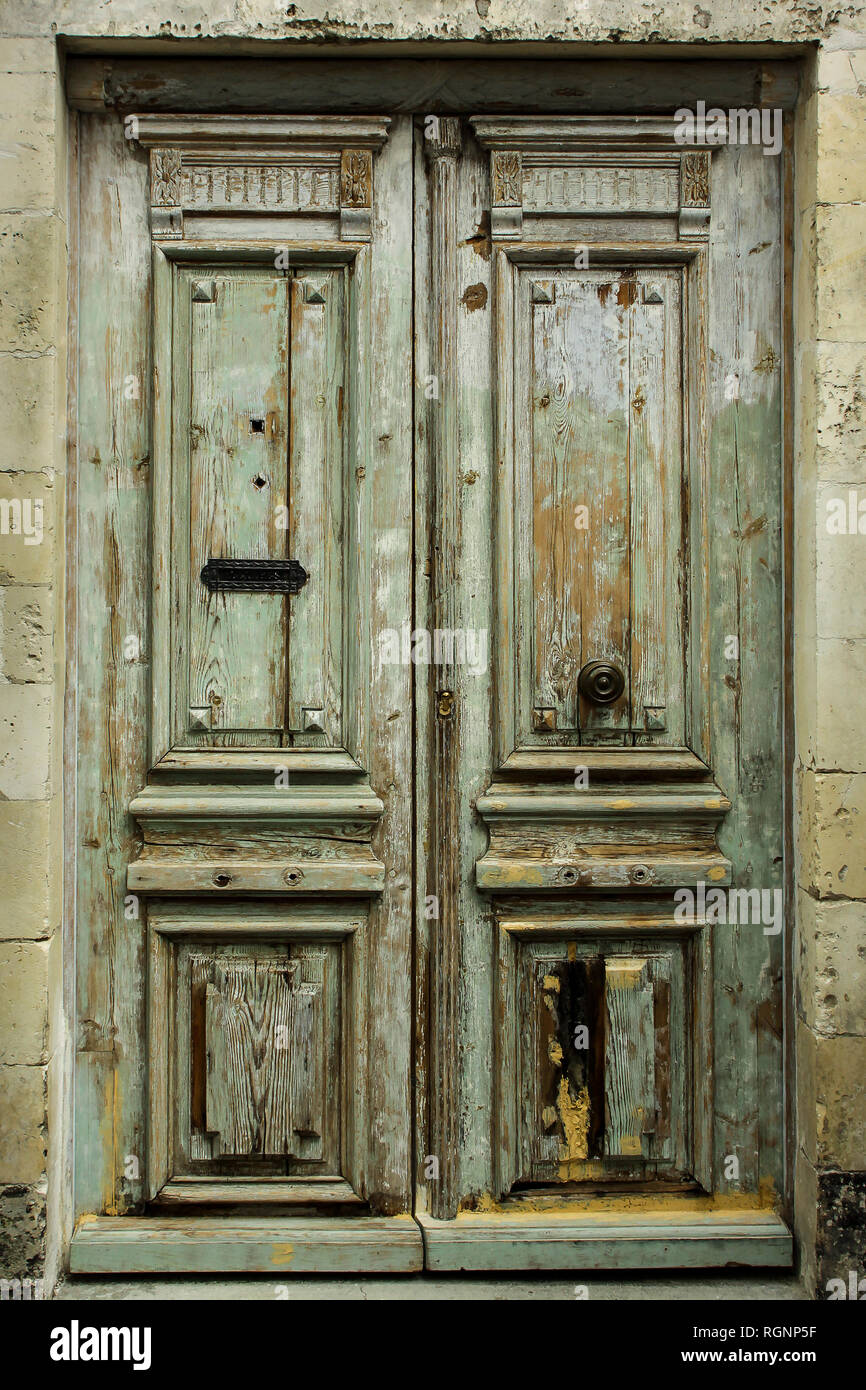 Old rustic green french door with lots of character. Stock Photo