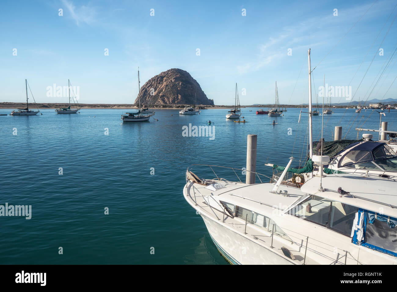 Morro Bay harbor, California. Sailing boats, Morro Rock, blue sea, and