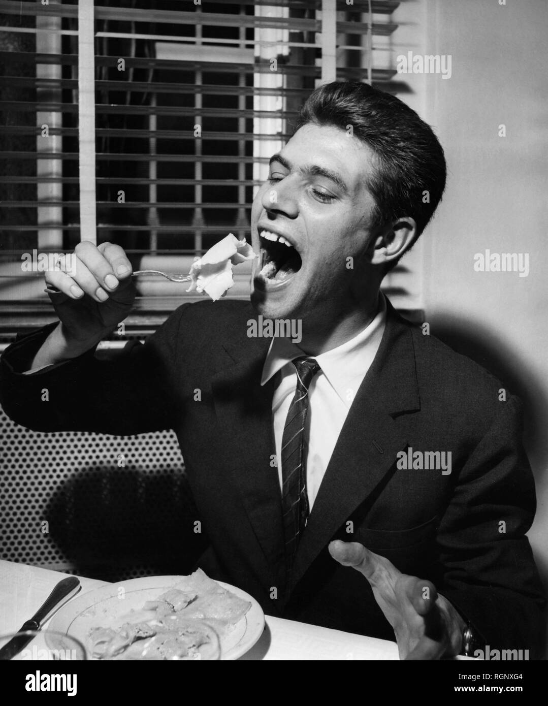 man eating italian food, tortelli with vegetables, 1964 Stock Photo