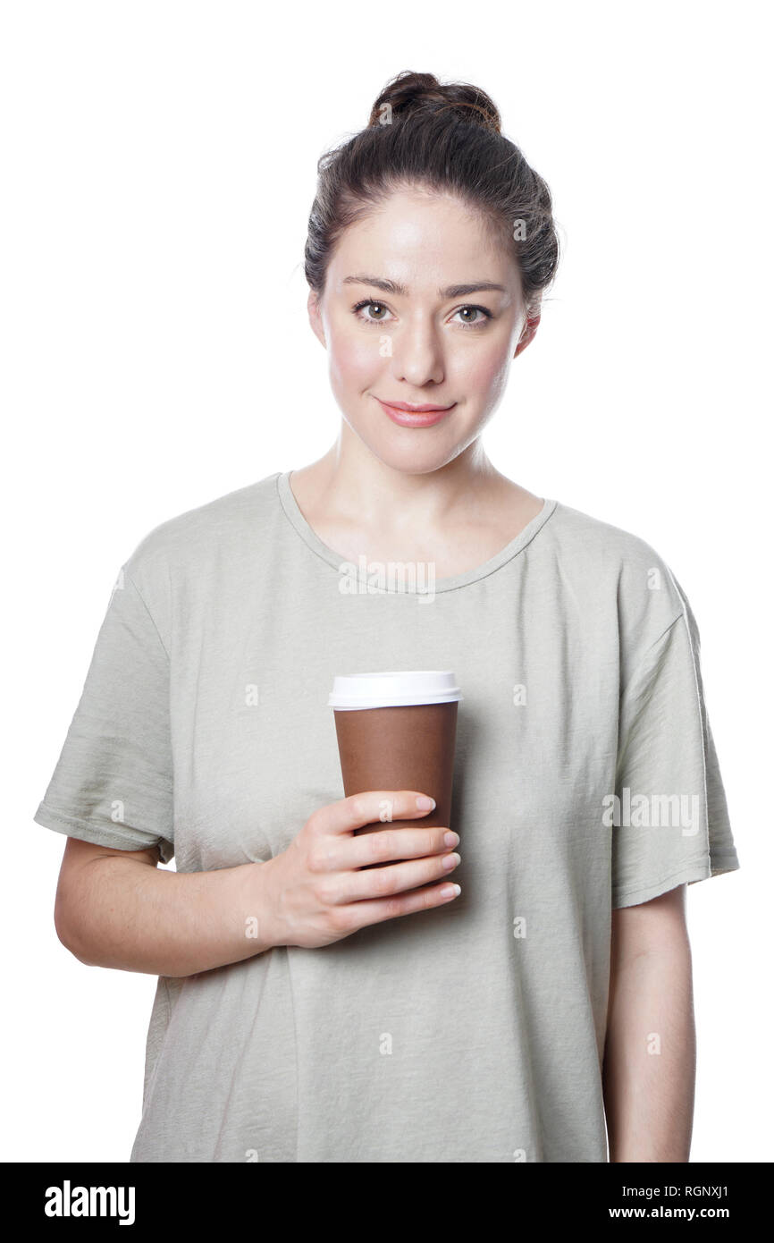cheerful young woman holding coffee to go in disposable cup Stock Photo