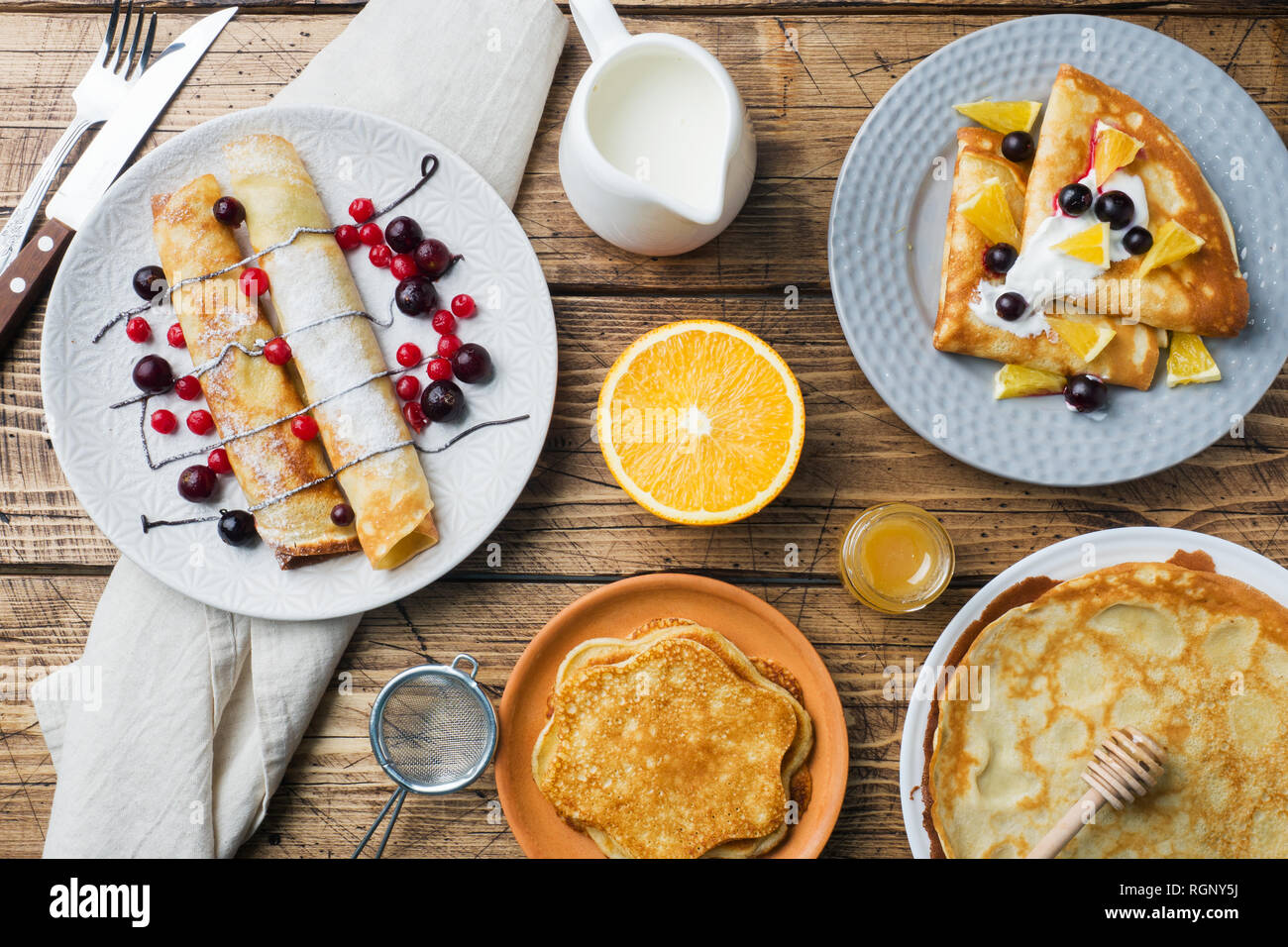 Pancake Types Different types of pancakes with berries on a wooden table Stock Photo ...