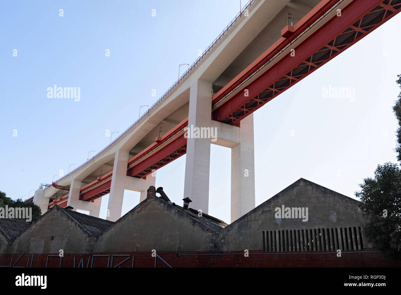 Lisbon bridge Ponte 25 de Abril over spans houses and districts. Stock Photo