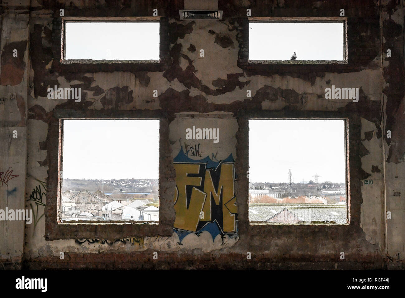 A small patch of old graffiti remains between flakey window apertures, inside the former Bristol Royal Mail sorting office, which is scheduled for demolition on 30th January 2019 after standing empty for 22 years, bringing an end to a building that became a playground for squatters, illegal ravers and fledgling graffiti artists. Stock Photo