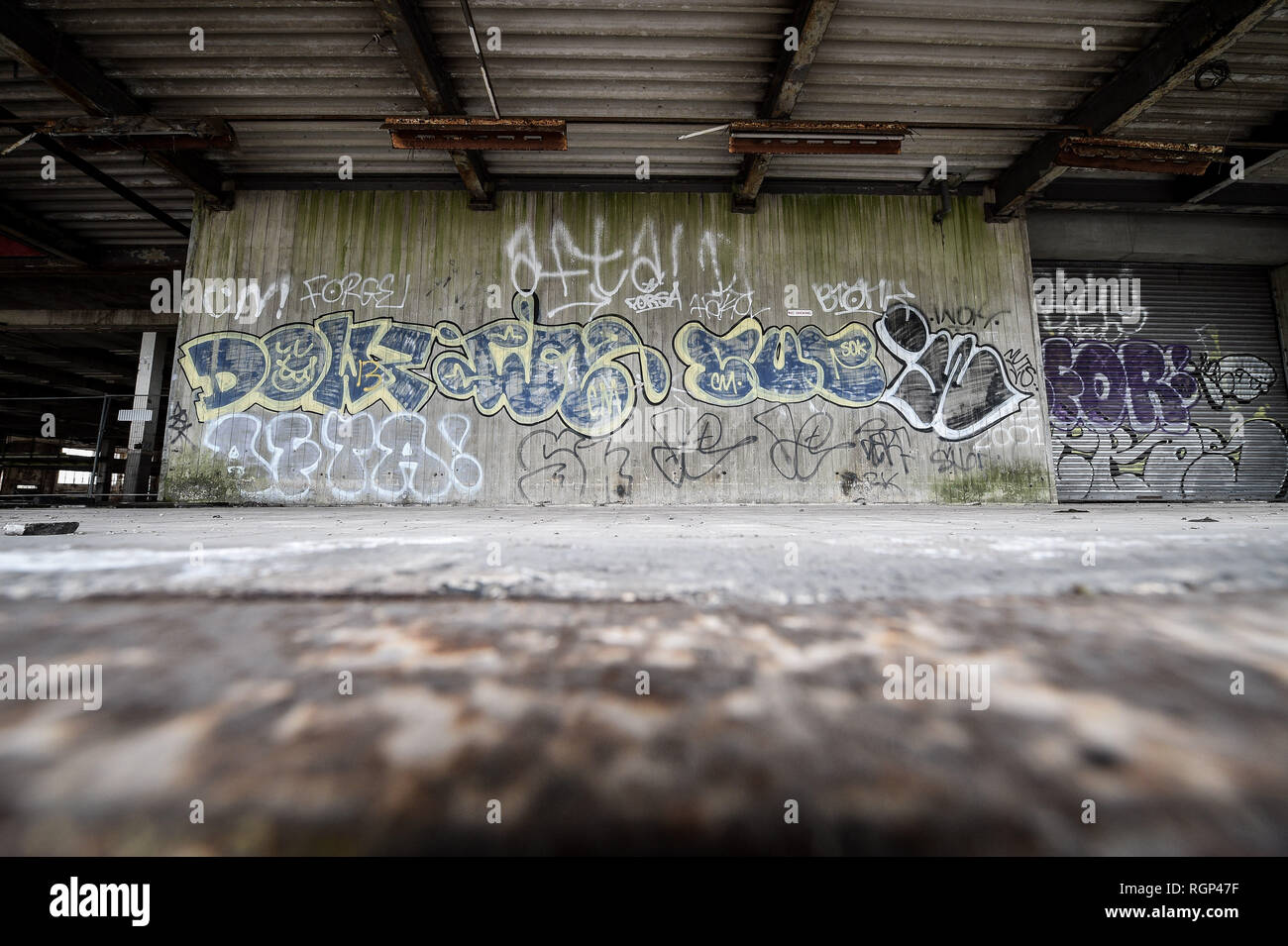 Graffiti on the loading bay outside the former Bristol Royal Mail sorting office, which is scheduled for demolition on 30th January 2019 after standing empty for 22 years, bringing an end to a building that became a playground for squatters, illegal ravers and fledgling graffiti artists. Stock Photo