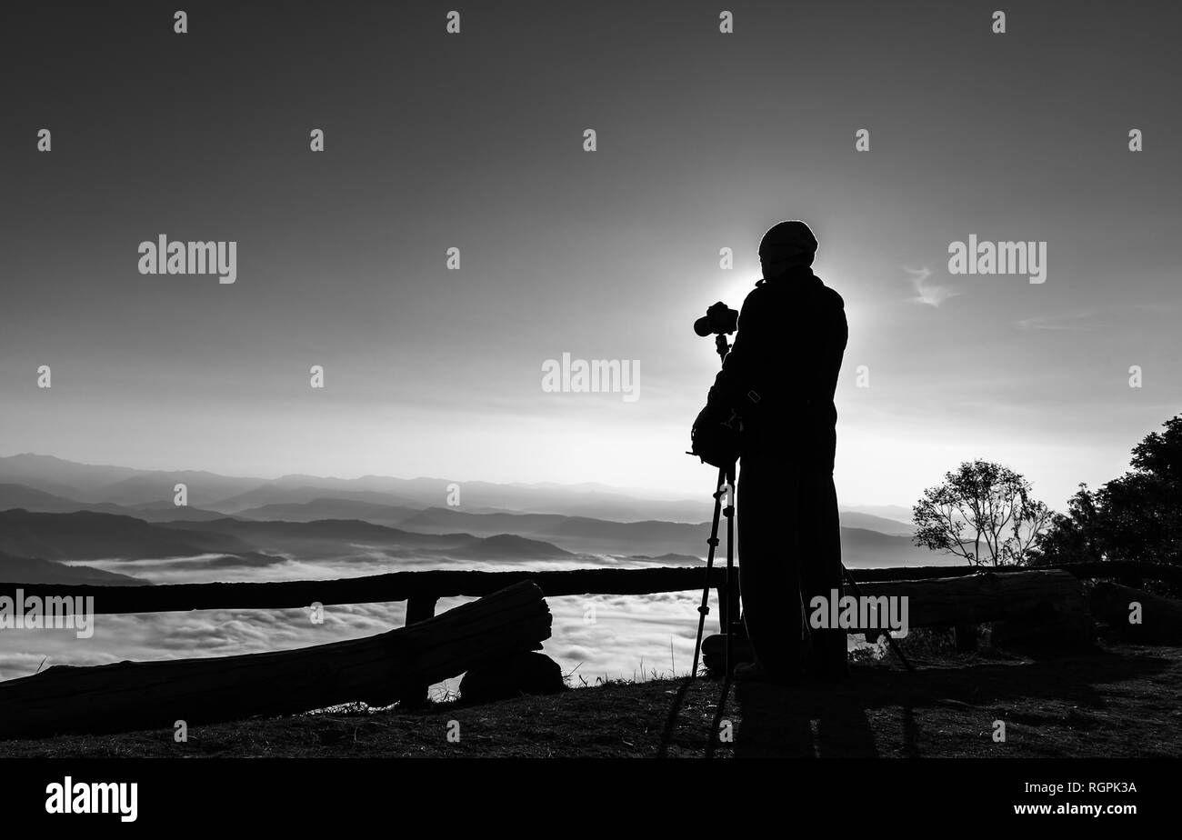 Silhouette of photographer taking photos. Filter effect style Stock Photo