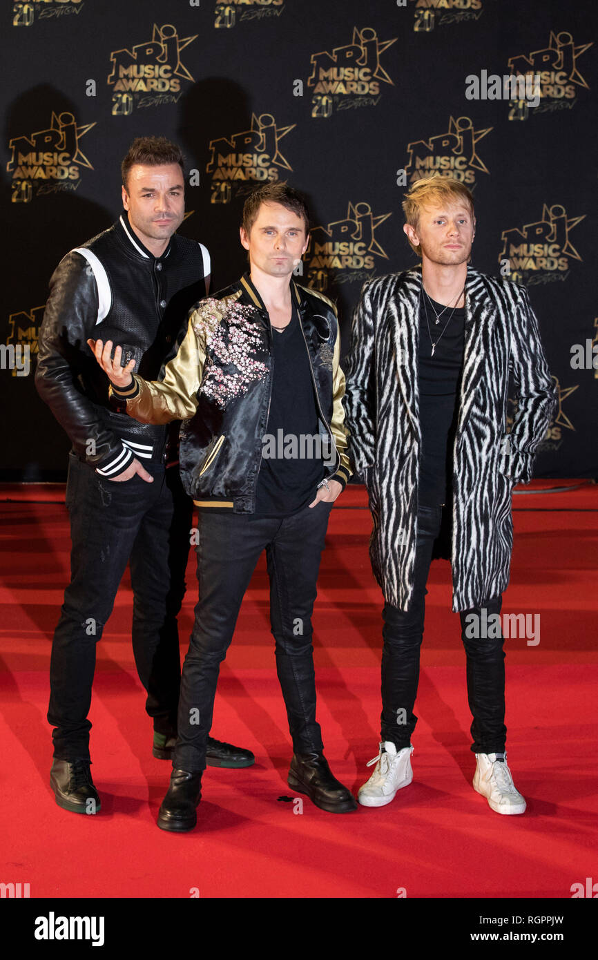 MUSE, Matt Bellamy (singer), Chris Wolstenholme (bass), Dominic Howard (drums) on the red carpet before the 20th NRJ Music Awards ceremony in Cannes ( Stock Photo