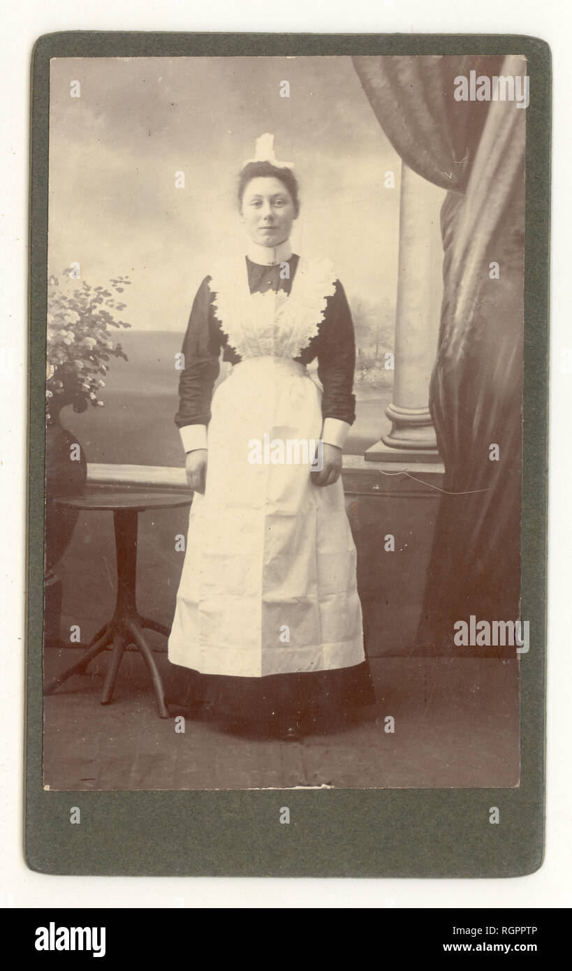 Edwardian Carte de Visite portrait of maid wearing lace bib to apron and lace cap, circa 1903, U.K. Stock Photo