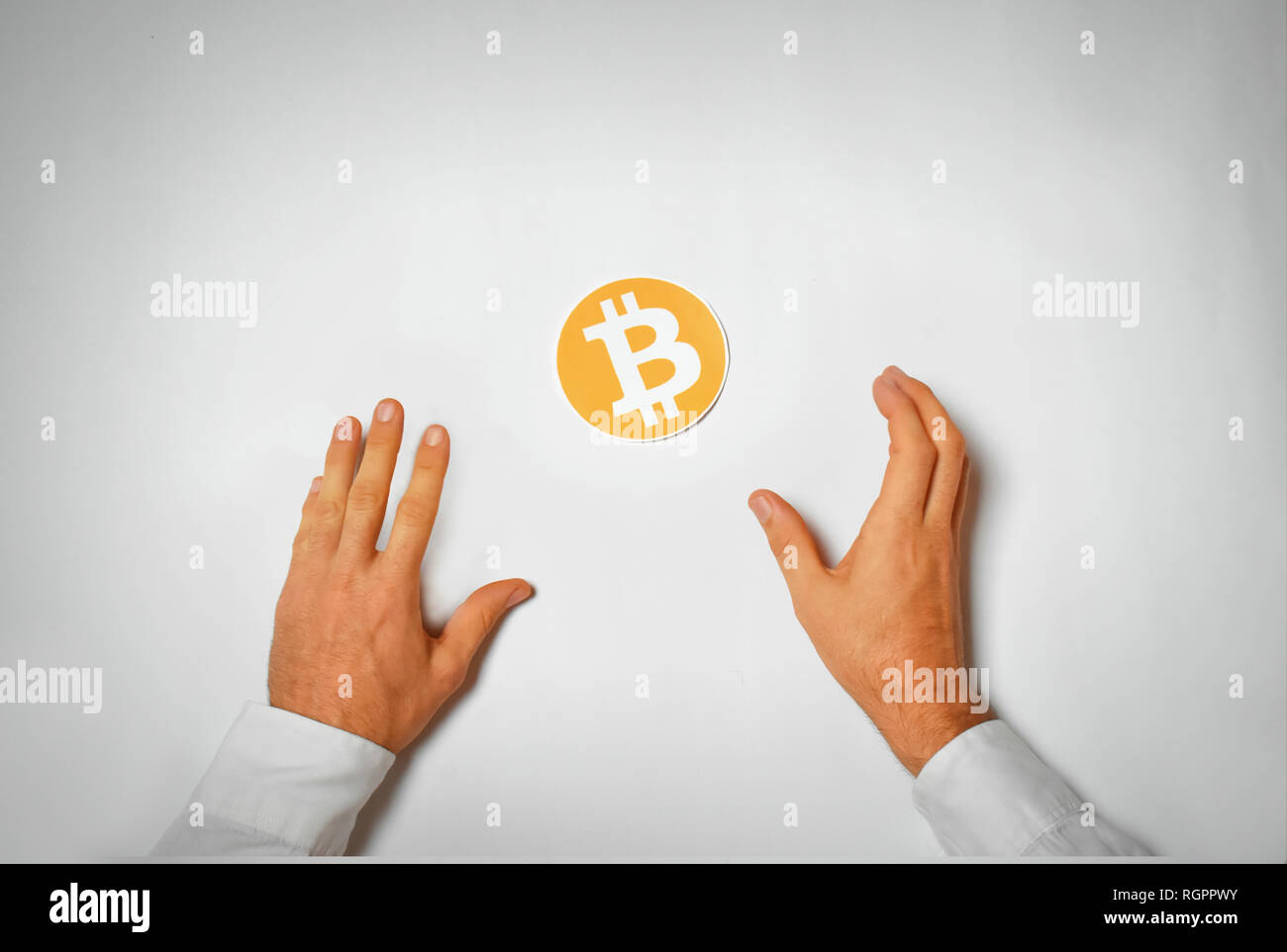 Two arms greedily looking for Bitcoin Stock Photo