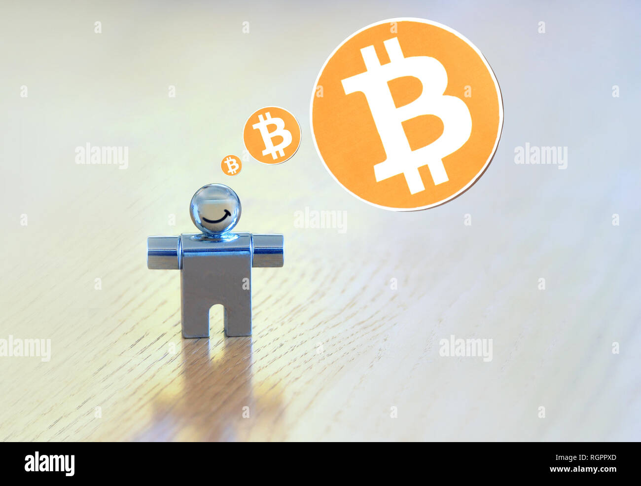 smiling figure with a bitcoin thought bubble Stock Photo