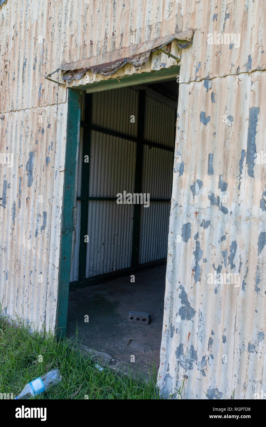 Metal Barn Rusted A close up front view of a old rusted run down metal barn or storage ...