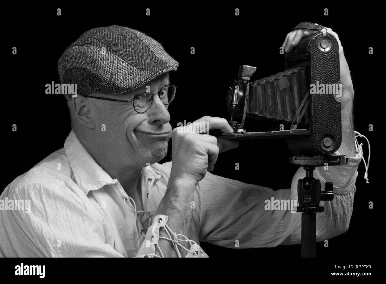 Portrait, man photographing himself with bellows camera, pulls grimace, Germany Stock Photo