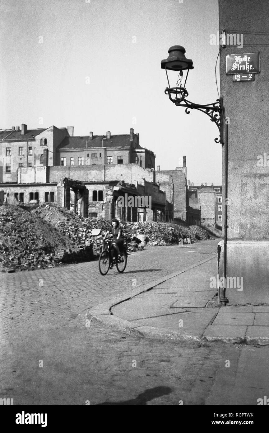 Woman on a bicycle riding through ruins, 1947, Hohe Straße corner Bernhard-Göring-Straße, Leipzig, Saxony, GDR, Germany Stock Photo
