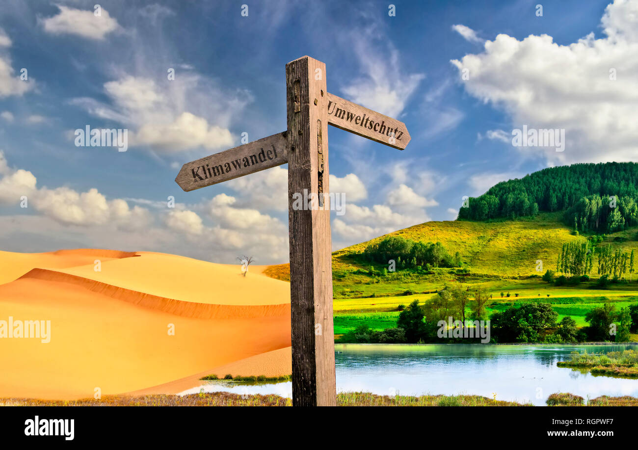 Signpost to environmental protection with the inscription climate change to the left and environmental protection to the right. Green landscape or cli Stock Photo