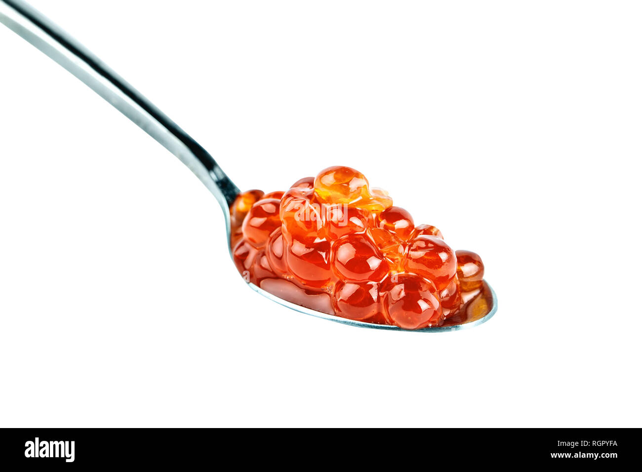 Red caviar in the silver spoon. Isolated object on white background. Close up. Stock Photo