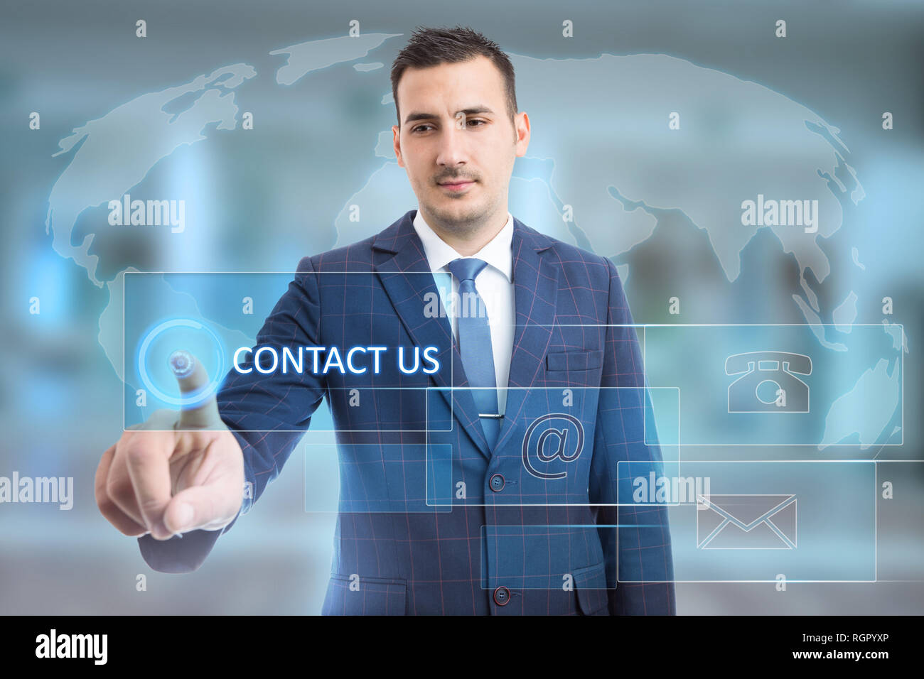 Man touching contact us button using index finger on transparent display with phone and email symbols on world map background Stock Photo