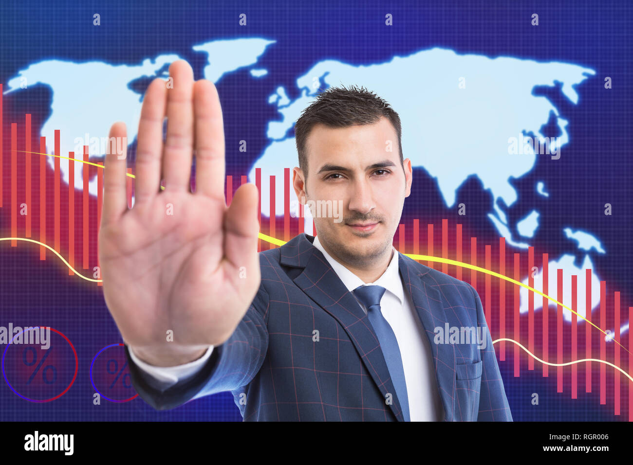 Business man showing palm as stop gesture because of drop in stock market with red decreasing graph and world map background Stock Photo