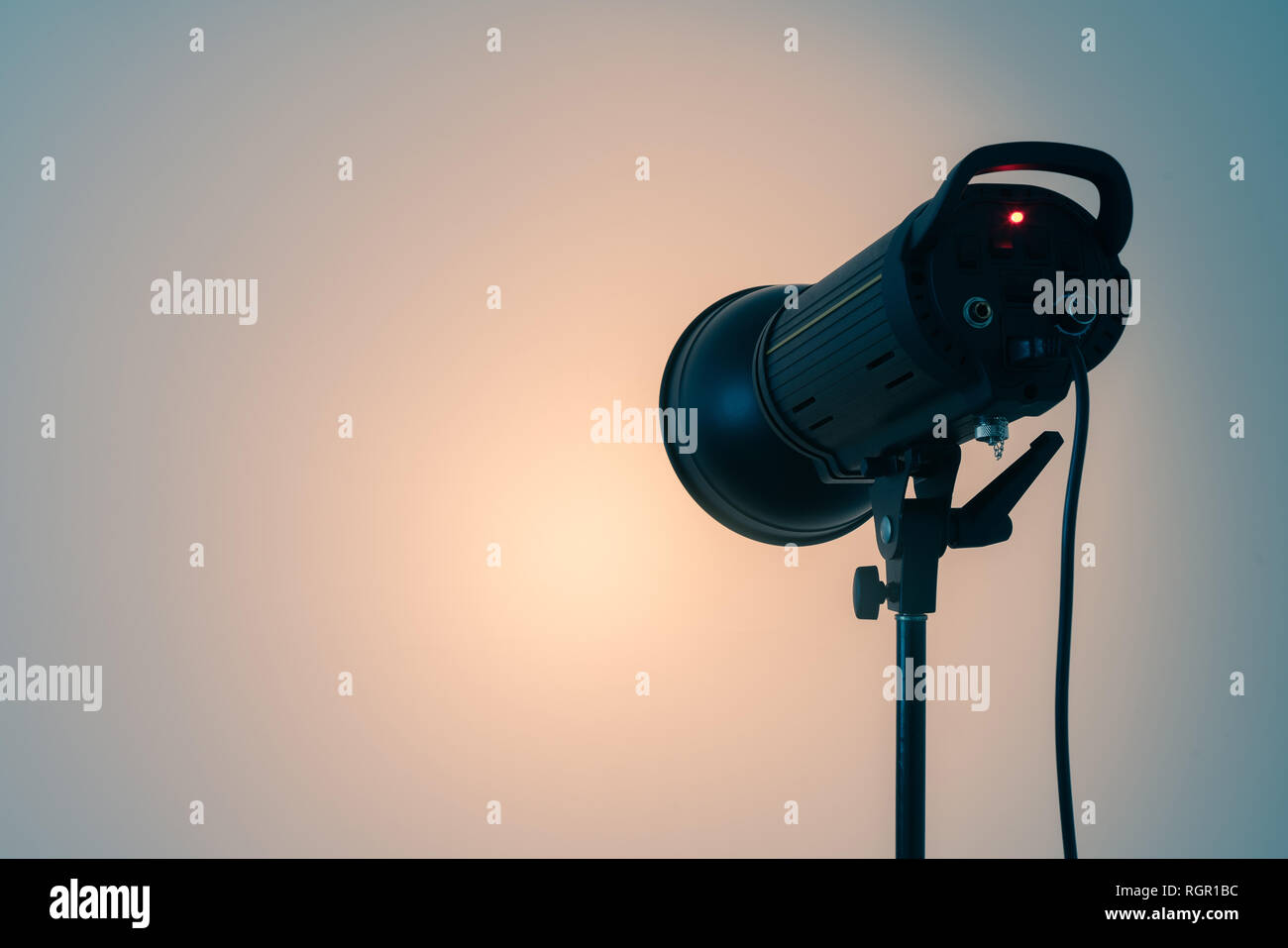 Studio light on the stand. Spotlight on white wall background. Copy space for text Stock Photo