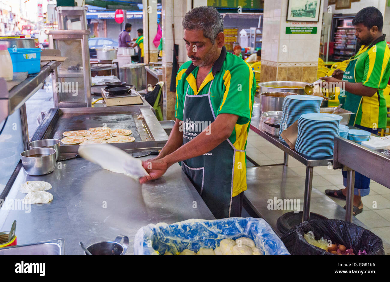 making of Roti Canai. Roti canai  is a type of Indian-influenced flatbread found in George Town, Penang, Malaysia Stock Photo