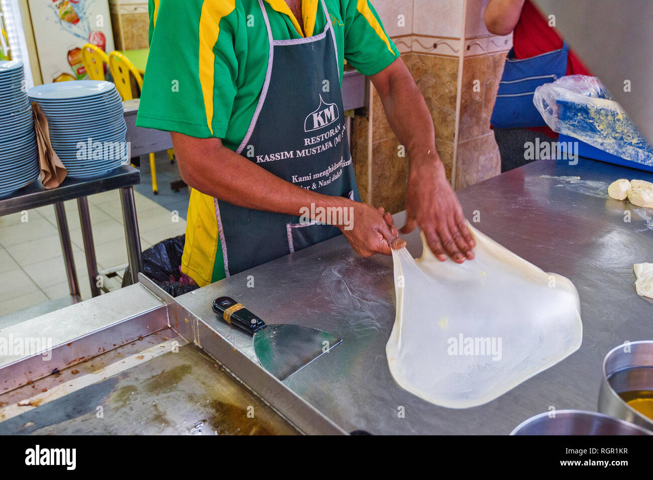 making of Roti Canai. Roti canai  is a type of Indian-influenced flatbread found in George Town, Penang, Malaysia Stock Photo