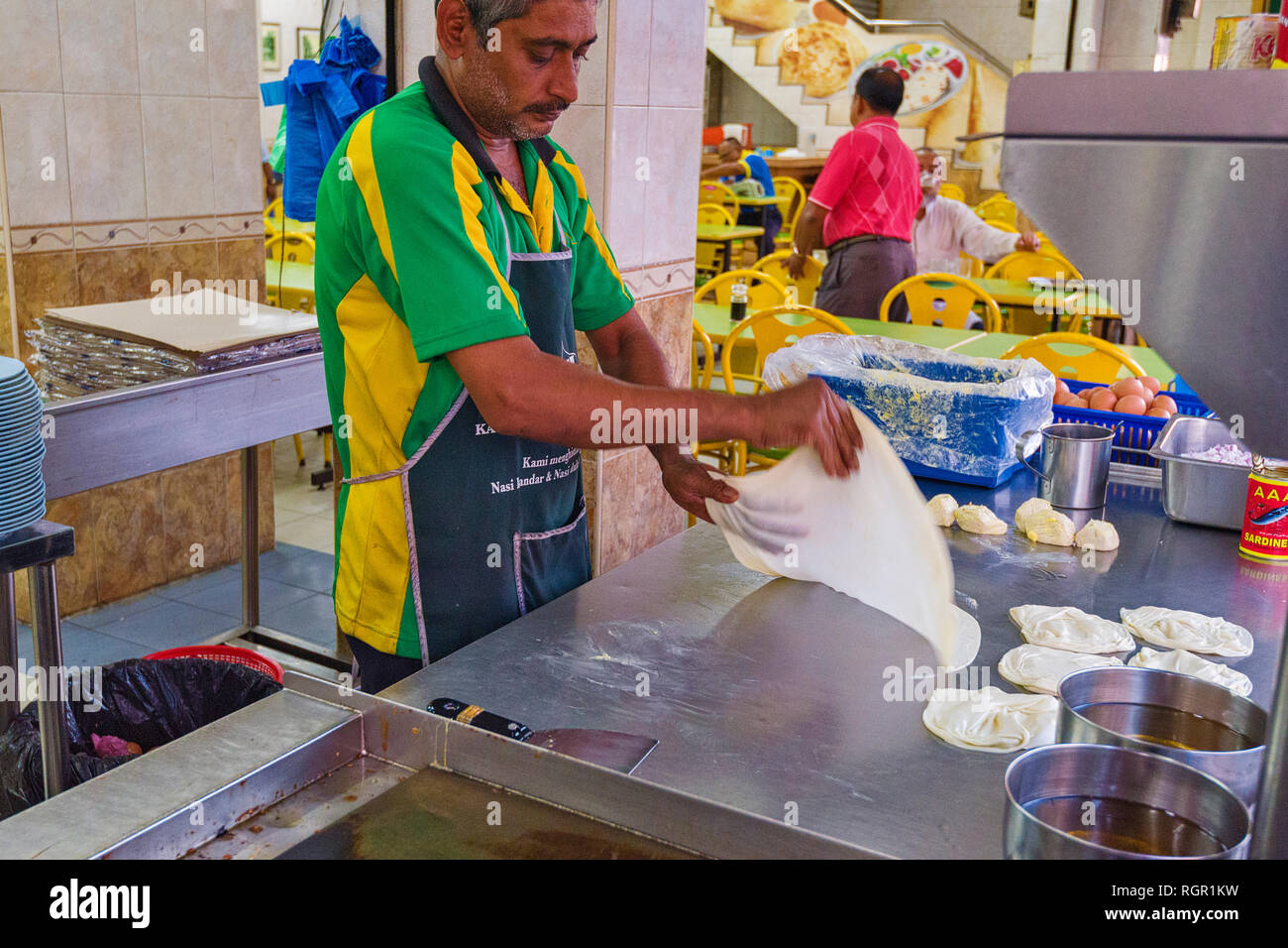 making of Roti Canai. Roti canai  is a type of Indian-influenced flatbread found in George Town, Penang, Malaysia Stock Photo