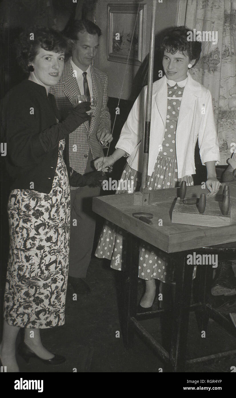 1950s, historical, two ladies playing a traditional British game of bar or table skittles in a pub, England, UK. Stock Photo