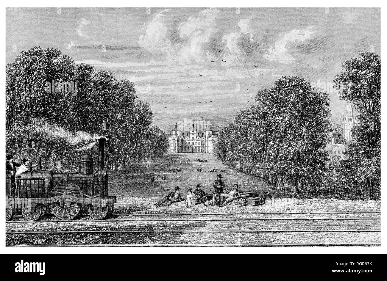 Steam train passing the Elizabethan manor-house erected by Sir Thomas Holt Stock Photo
