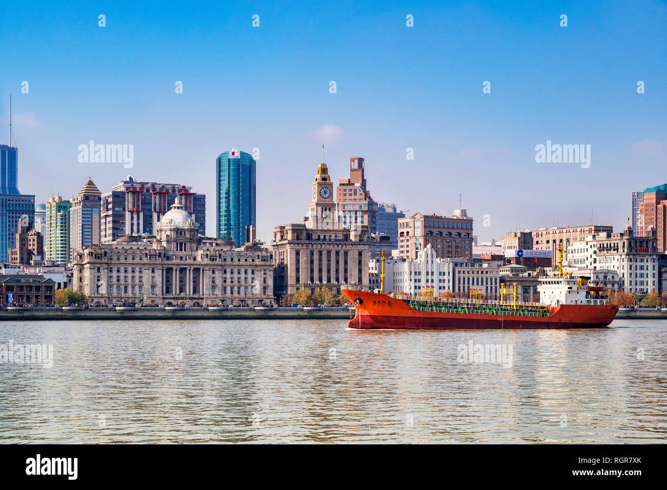 1 December 2018: Shanghai, China - Cargo ship on the Huangpu River passing The Bund, the historic business area of Shanghai. Stock Photo
