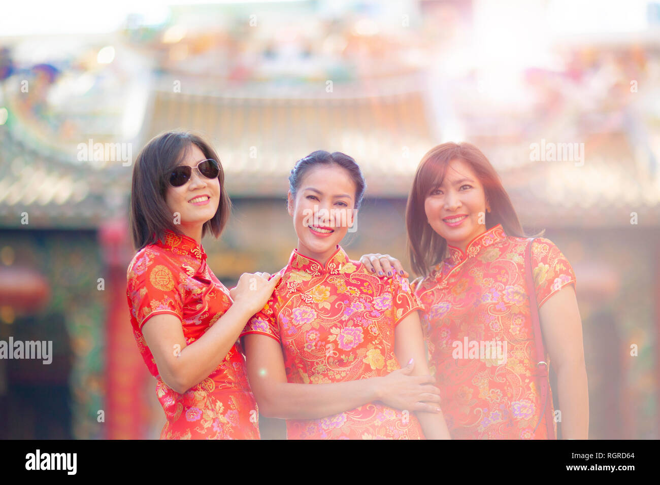 three asian woman smiling face standing against blur background of chinese thrine in bangkok thailand Stock Photo