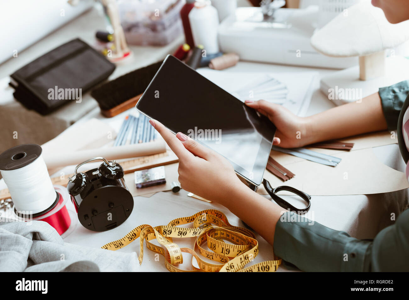 New technologies in design. Cropped photo of young woman tailor with ...