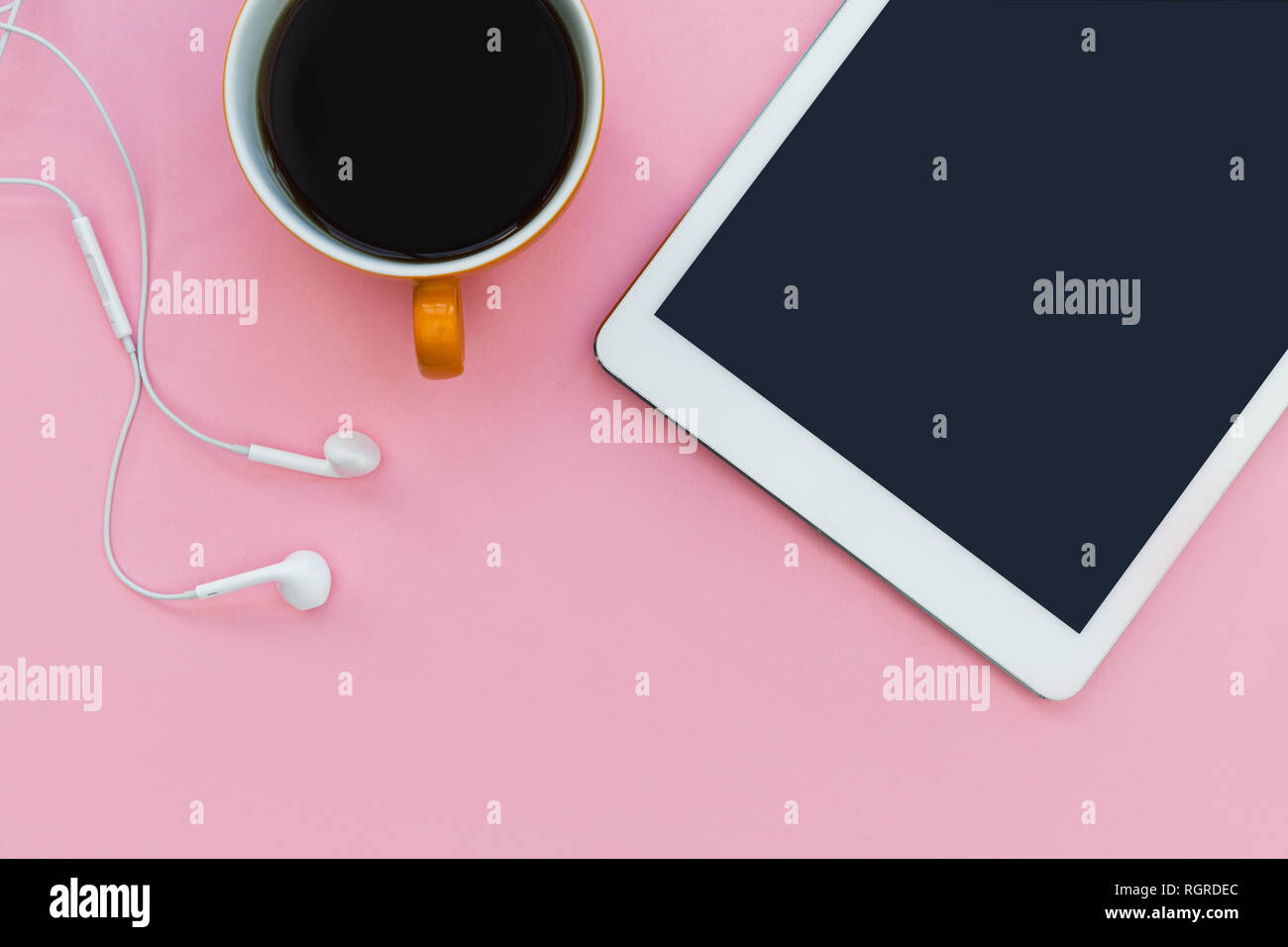 White tablet computer with coffee cup on pink color background minimal office Stock Photo