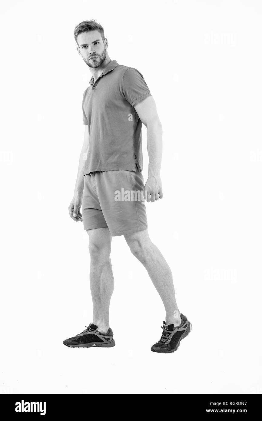 Macho wear clothes for active lifestyle workout or training. Man sport clothes isolated on white background. Bearded man in blue casual clothes. Sport fashion style and trend. Fitness and gym clothes. Stock Photo