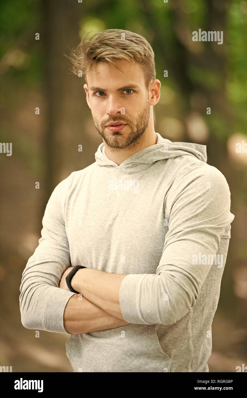 Sportsman training with pedometer gadget. Man athlete on strict face ...