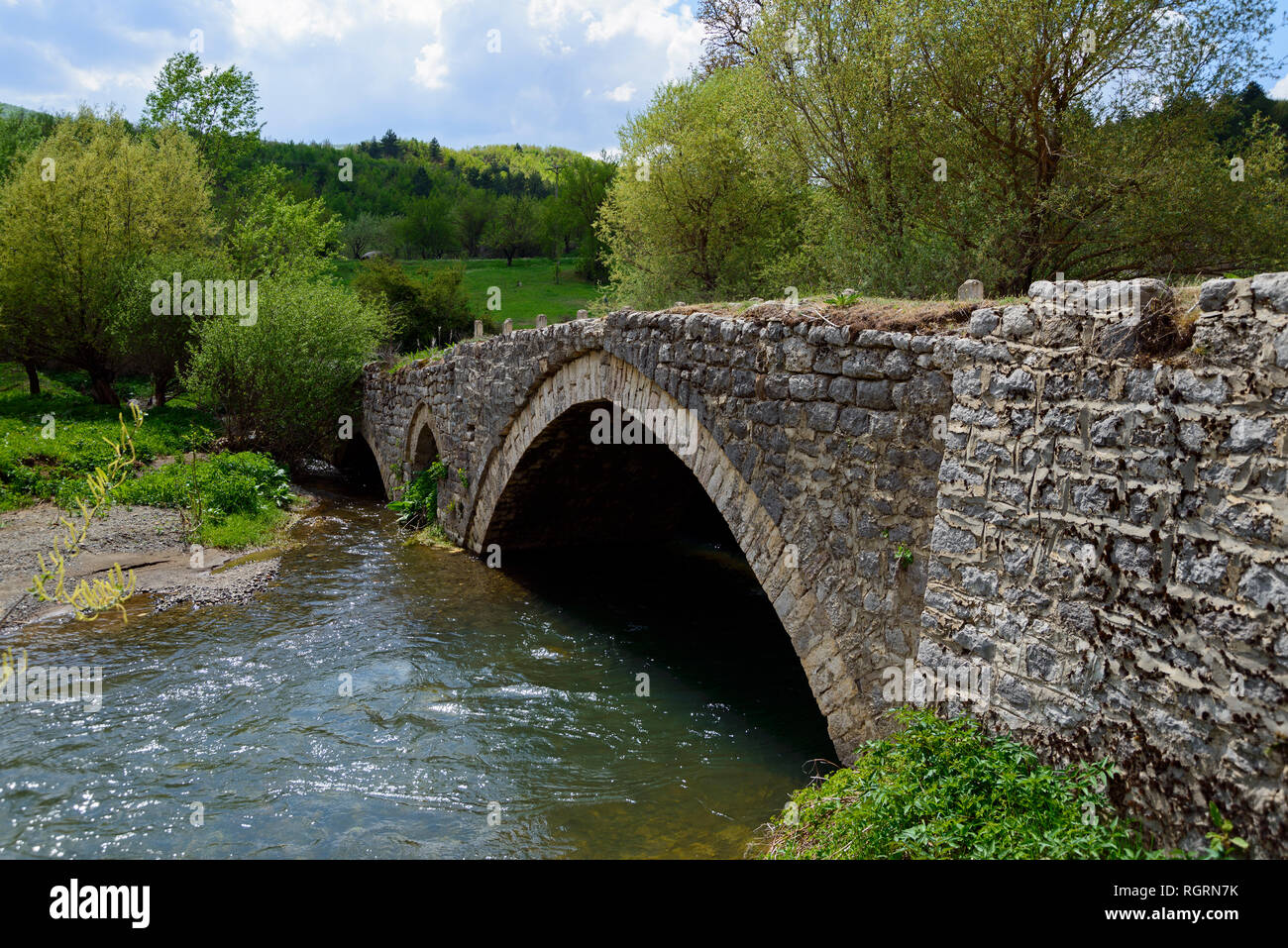 Stone arch bridge, river Osum, Vithkuq, Albania Stock Photo