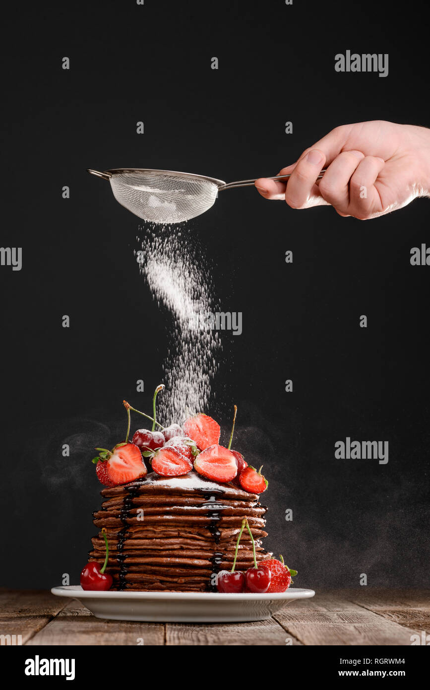Dusting powdered sugar on dessert Stock Photo Alamy