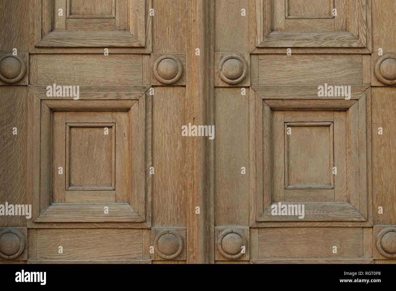 Old wooden gate with squares and circles motif. Antique door detail
