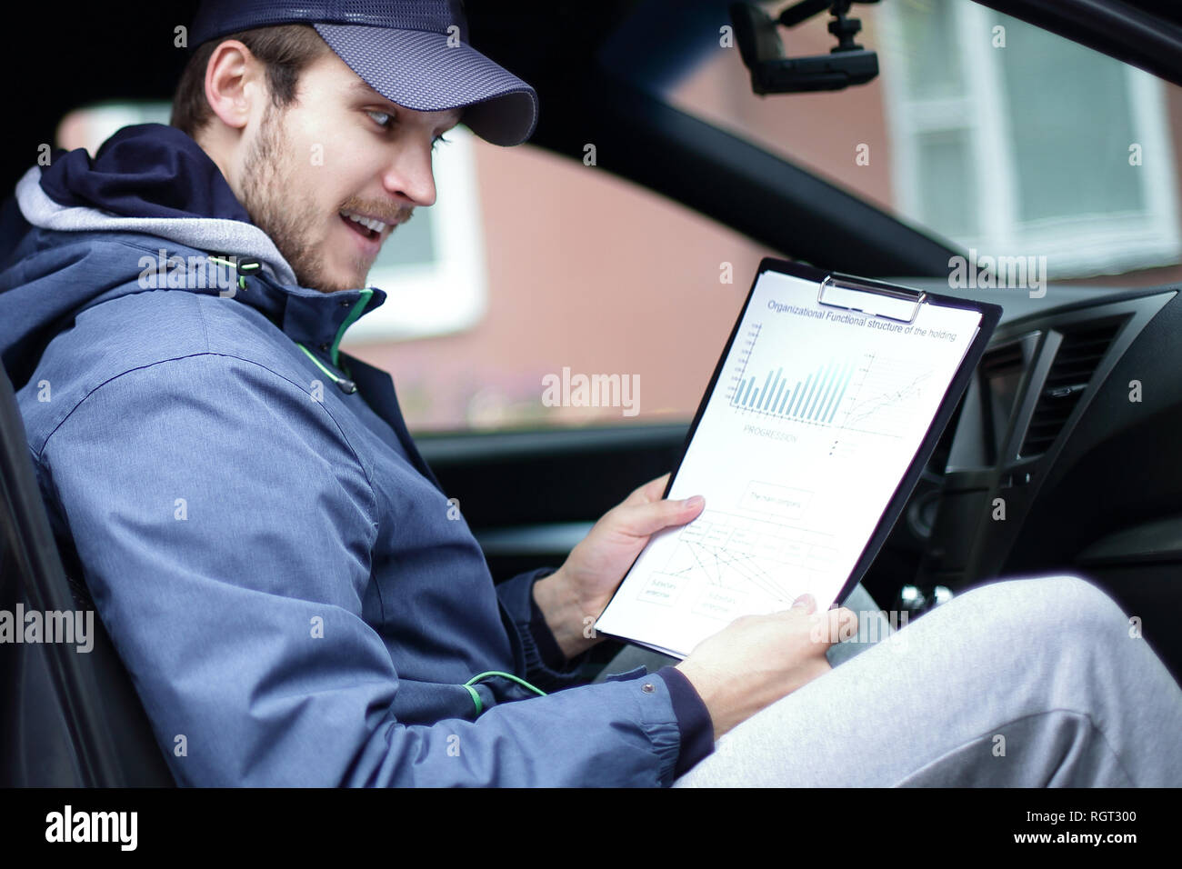 man with documents sitting in the car Stock Photo