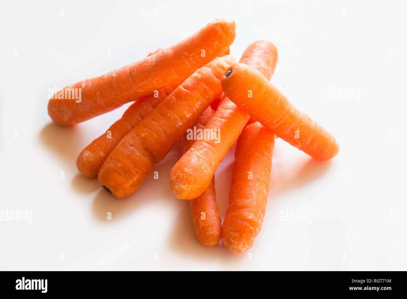Bright orange carrots on a plain white background Stock Photo