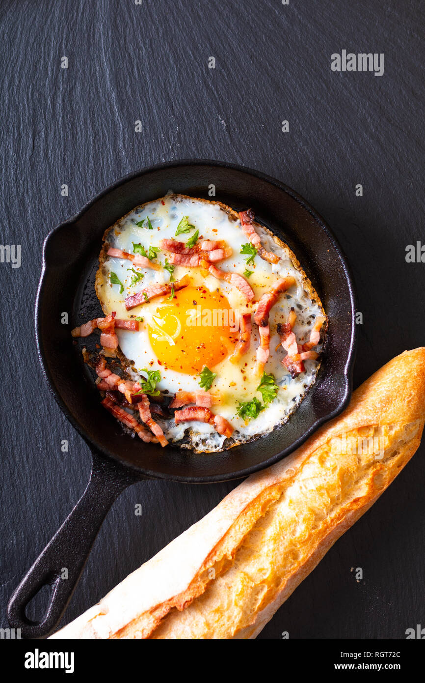Food concept Fried egg and cheese bacon in cast iron skillet with copy