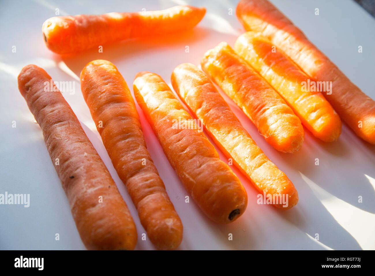 Bright orange carrots on a plain white background Stock Photo