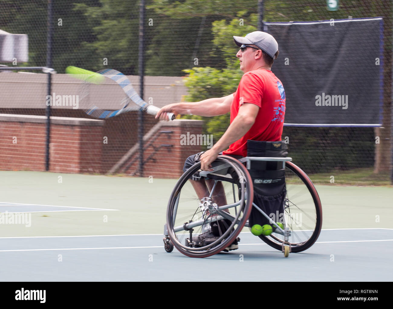 A wheelchair athlete playing tennis as part of the Adaptive Sports