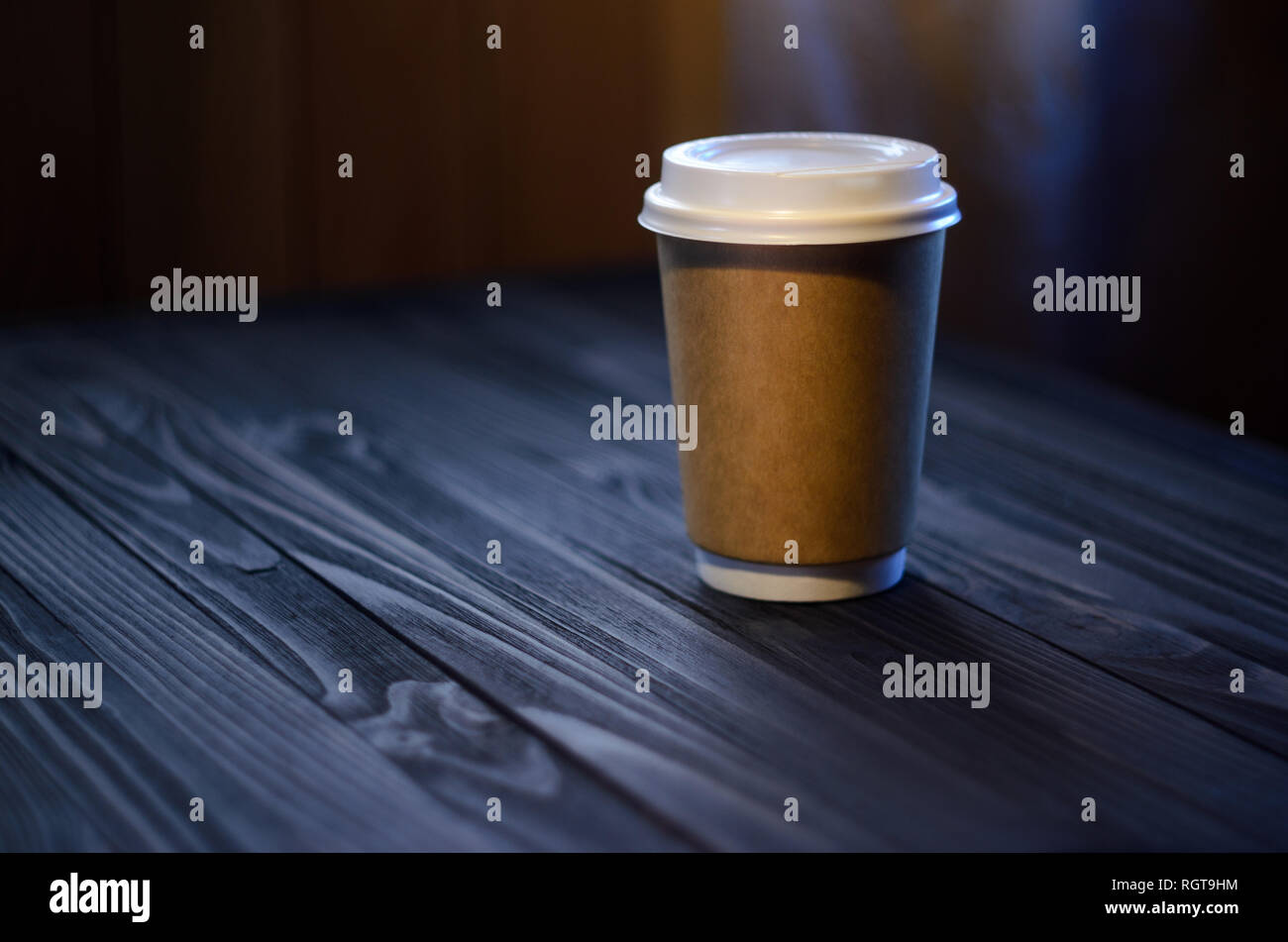 A cup of coffee on the table. Paper cup Wooden table Plastic cap Coffee Expectation. Coffee take