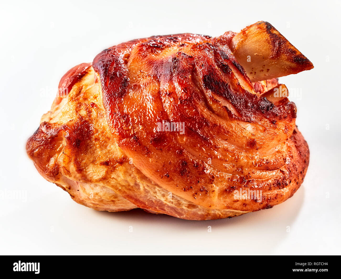 A crispy, golden roasted pork knuckle on a white background with copy